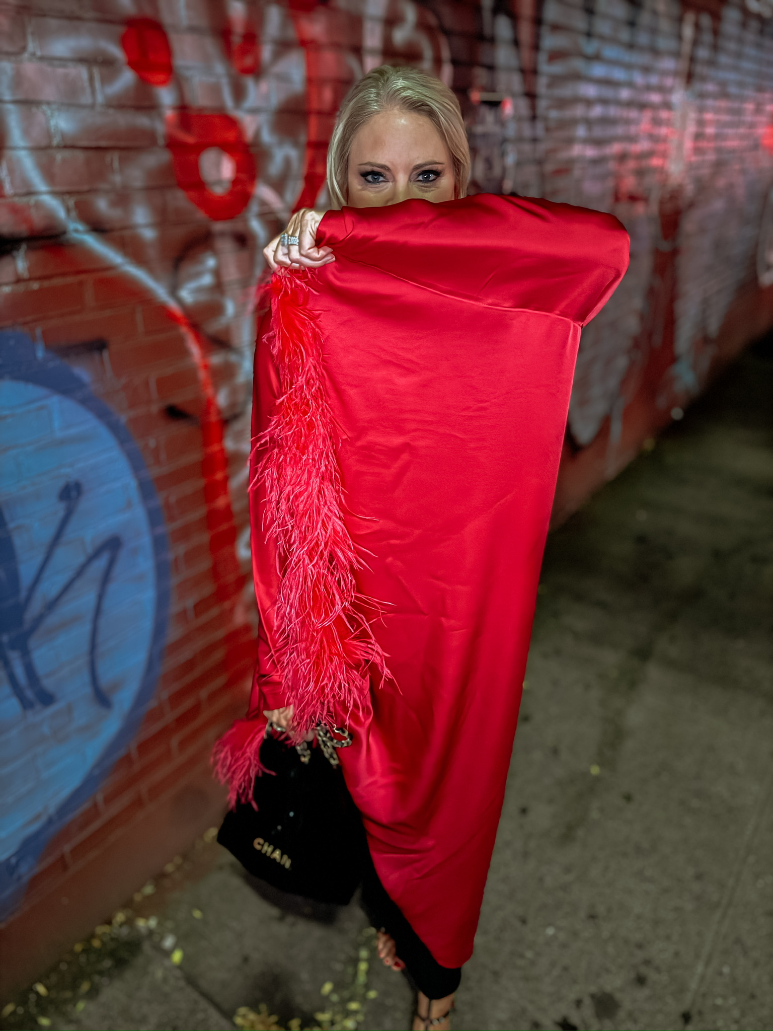 my new york fashion week experience, amy wearing black shapewear  dress with red cape